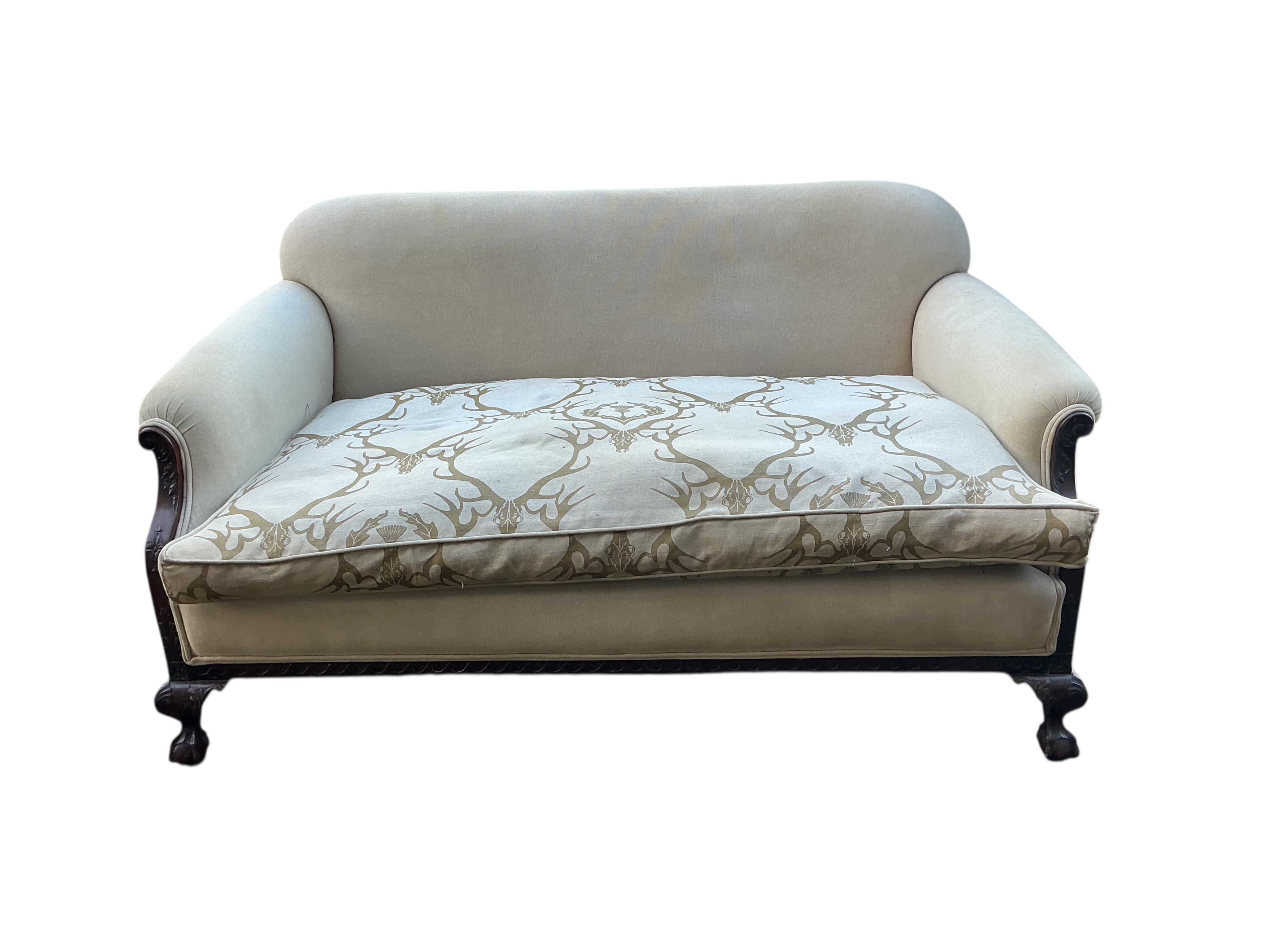 An early 20th century upholstered settee with stag head printed cushion seat, width 150cm, depth 84cm, height 76cm